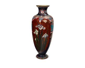 1192
20th century
A Japanese Musen-Style Cloisonné Vase
Appears unmarked
The polychrome enameled vessel with opposing registers of lilies surrounded by dragon and scrollwork motifs
24" H x 8" Dia.
Estimate: $500 - $700
