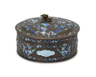1193
Late 19th century
A Chinese Cloisonné And Bronze Box
Stamped on the underside: China
The circular bronze body with royal blue and teal enameled motif of birds and foliate; lidded with a guardian lion-shaped finial
2.5" H x 6.25" Dia.
Estimate: $200 - $400