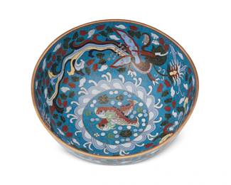 1194
20th century
A Chinese Cloisonné Bowl
Marked to the underside bearing an apocryphal reign mark for Qianlong Period (1736-1795)
The polychrome enamel and brass bowl with an interior featuring two dragons and cloud motifs on a blue ground centering two fish, and an exterior with two matching dragons
4" H x 9.125" Dia.
Estimate: $500 - $700