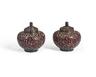 1196
20th century
A Pair Of Chinese Tixi Lacquered Jars
Each appears unmarked
The brass and lacquer globular form lidded jars, each with all-over scrolled ruyi motifs in v-shaped carving revealing layers of black and red lacquer, 2 pieces
Each: 4.125" H x 4" Dia.
Estimate: $300 - $500