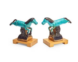 1215
Late Qing Dynasty 1644-1912 or later
A Pair Of Chinese Turquoise Glazed Ceramic Roof Tiles
Each appears unmarked
Each in the form of a horse with all-over turquoise and deep purple glaze; mounted to later added custom wood stands
Each with stand: 10.5" H x 5.25" W x 12.5" D
Estimate: $300 - $500