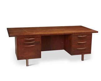 1231
Mid-20th century
A Jens Risom Executive Desk
With metal tag to interior of top drawer: R / Jens Risom Design
The walnut wood desk with two side modules, each featuring three drawers with carved wood pulls and a pull-out surface, one top drawer with an accessory caddy, one bottom drawer filing cabinet, two with locking mechanism, all raised on four legs with channeled metal strips
27.5" H x 80" W x 36" D
Estimate: $500 - $700