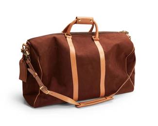 1260
Late 20th century
A French Luggage Co. USA Weekender Bag
Marked to chain and locks for French / Covina, Ca / U.S.A.; interior label: America's Finest Handcrafted Luggage / Made in California / USA
Brushed brown microsuede bag with brass-toned hardware, tan leather handles, a cotton-mix lining and interior pockets, with tan shoulder strap, luggage tag and YKK zippers throughout
13.25" H x 22" W x 11" D
Estimate: $200 - $300