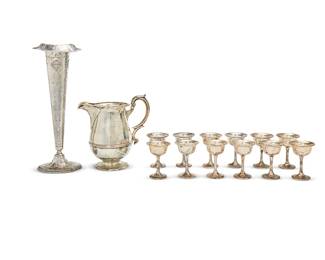 1310
Late 19th/early 20th century
A Group Of Silver Table Items
Pitcher marked for Gorham sterling; cups marked: Shreve, Treat, & Eacret / Sterling / Base Loaded; vase marked: E.G. Webster & Son / F4 16
Comprising 11 weighted silver cups (4.25" H x 3" Dia.), 1 sterling silver pitcher with a scrolled leaf handle (9.5" H x 9.75" W x 6" D), and 1 weighted silver vase decorated in allover repousse scrolled and foliate motifs (16.325" H x 5.75" W x 5" D), 13 pieces
Weighable sterling: 33.235 oz. troy approximately
Estimate: $200 - $300