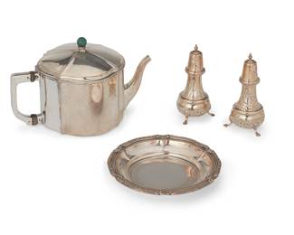 1311
Late 19th/early 20th century
A Group Of Sterling And Coin Silver Table Items
Teapot and tray marked for 800 / [moon and crown]; tray further marked for retailer: H Maass; each shaker marked for: Sterling / 440
Comprising one German coin silver tray with foliate decoration to the rim, one German coin silver teapot with green gemstone finial, and a pair of sterling salt and pepper shakers with all-over chased floral motif, 4 pieces

Largest: 5.5" H x 9" Dia.; smallest: 5.25" H x 2.5" Dia.
29.735 gross oz. troy approximately
Estimate: $800 - $1,200