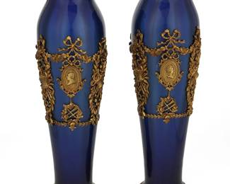 1314
Late 19th/early 20th century
A Pair Of Continental Cobalt Glass Vases
Each slender vase with blown cobalt blue glass body with gilt-bronze floral mounts centering portrait roundels, 2 pieces
Each: 12.75" H x 3.75" Dia.
Estimate: $500 - $750