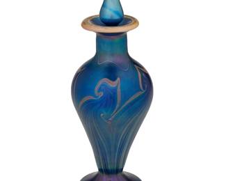 1316
20th century
A L.C. Tiffany-Style Perfume Bottle
Spuriously engraved: L.C. Tiffany
The cobalt blue iridescent bottle featuring a marbleized design in the manner of Favrile glass, with attendant stopper
8.125" H x 2.75" Dia.
Estimate: $200 - $400
