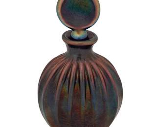 1317
20th century
A L.C. Tiffany-Style Perfume Bottle
Spuriously engraved: L.C. Tiffany
The cobalt blue iridescent bottle with ribbed body and disc stopper
4.625" H x 2.5" W x 1.25" D
Estimate: $200 - $400