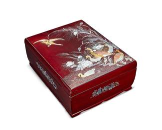 1339
Mid-20th century
An East Asian Lacquered Box
With mother of pearl inlaid mark of a ginko leaf to the underside
The oxblood lacquered lidded wood box with low relief mother of pearl inlay depicting a scene of waterfowl on a reed-lined riverbank and further decorated with avian and floral motifs to each side, raised on a carved wood base
6.75" H x 15.5" W x 12.125" D
Estimate: $500 - $700