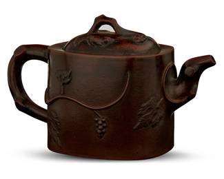 1340
20th century
A Chinese Yixing Zisha Earthenware Teapot
Embossed to the underside with a four-character maker's mark
With foliate motifs in raised relief, along with a blue cloth-covered case, 2 pieces
4.5" H x 3.25" W x 7" D
Estimate: $100 - $200