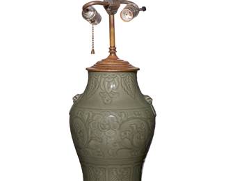 1354
Late 19th/early 20th century
A Chinese Celadon Porcelain Table Lamp
Appears unmarked
The baluster form ceramic vase with all-over celadon glaze, incised foliate motifs, and opposed low-relief masks and ring handles, retrofitted as a two-light lamp, electrified
25" H x 9" Dia.
Estimate: $200 - $400