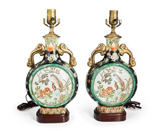 1355
20th century
A Pair Of Chinese Porcelain Moon Flask Table Lamps
Each appear unmarked
Each with enameled bird and flower reserves and gilt handles, now retrofitted as lamps on a carved wood base, electrified, 2 pieces
Each: 17.5" H x 8" W x 4.25" D
Estimate: $200 - $300
