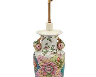 1356
Mid/late 20th century; Hong Kong
A Chinese-Style Tabacco Leaf Enameled Porcelain Lamp
Vase marked to the underside bearing an apocryphal reign mark in red enamel: Ya Wan Zhen Cang; further marked with a sticker: Made and Decorated in Hong Kong
The porcelain vase with Famille Rose enameled decoration with gilt accents depicting foliate and avian, likely Pheonix, motifs and applied three-dimensional pomegranate opposing handles to the neck retrofitted as a two-light lamp set on a carved wood base, electrified
24" H x 10" Dia.
Estimate: $200 - $400