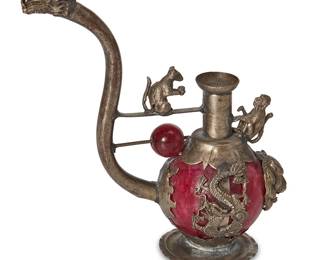 1367
Mid/late 20th century
A Chinese-Style Metal And Stone Pipe
The reproduction decorative pipe, in the style of a 19th century Chinese pipe, with red stone body and cast metal figural decoration
4" H x 2" W x 4.25" D
Estimate: $200 - $400