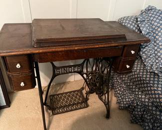 Singer sewing machine inside along with all implements & booklets in drawers