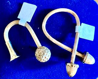 14k gold scarf ring and golf piece.