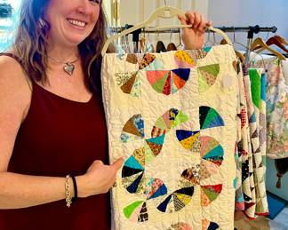 Christi showing off one of the many quilts.