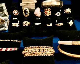 GOLD, DIAMONDS, RUBIES, JADE.  The family has removed the middle gold bracelet. 