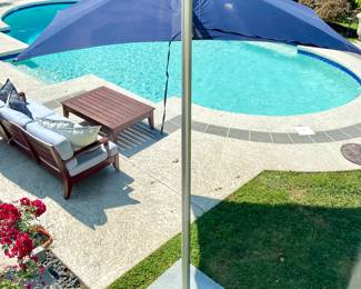  square cantilever umbrella by Tucci in excellent condtion; collapses and expands by easy-lift system with piston assist; compact yet solid with marine-grade aluminum that will resist the wind yet keep you covered (sells new for $3400); rear view