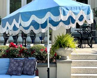 $350; large, blue and white fringed Treasure Garden patio umbrella with Sunbrella fabric and base; in great condition and such a fun piece