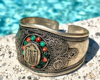 $50; silver cuff bracelet with stones in center