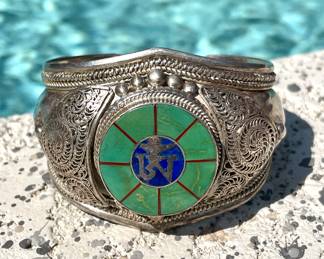 $100; sterling silver cuff with intricate scrolls 