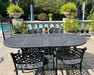 $800; 84 x 42 x 29 (table); 21 x 21 x 33 (chair); oval, cast-aluminum table and four arm chairs with one swivel, rocker arm chair by Hanamint