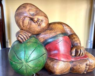 $100; 14 x 7 x 11; wood carved sleeping boy on watermelon