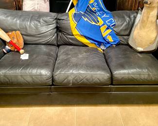 $600; well-loved Crate and Barrel, black leather sofa   