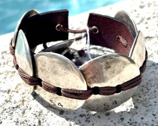 $50; Uno de 50 silver and leather bracelet