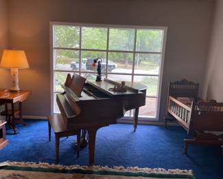 Baldwin baby grand piano and antique cradle