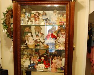 Display case with dolls