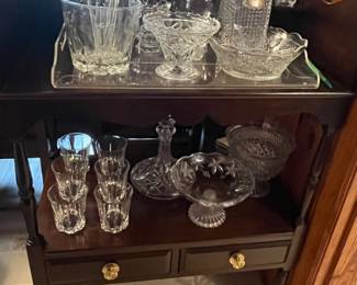 Crystal decanters and barware on bar stand
