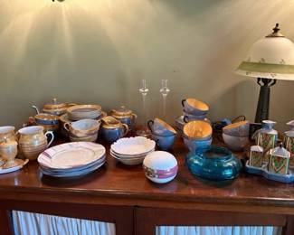 Teapot service, condiment service, mugs, plates, bowls, and lamp