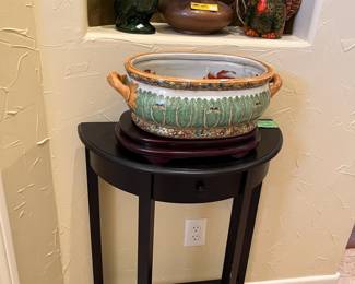 Half-round table with a beautiful Asian handled pot