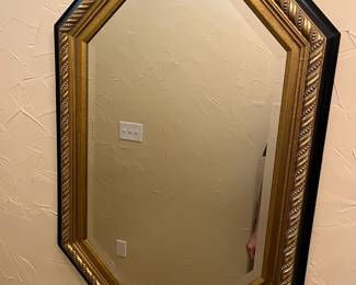 Large, beveled glass framed mirror.