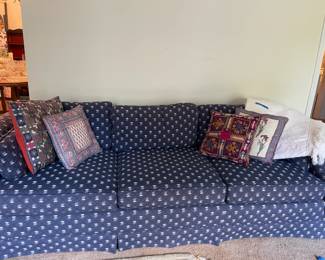 blue patterned sofa, throw pillows, white lap blanket