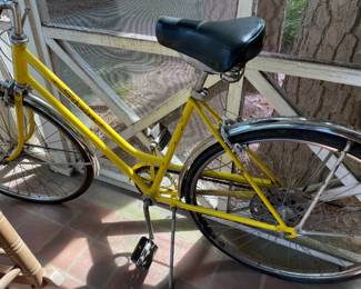 vintage yellow women's bicycle with chrome fenders