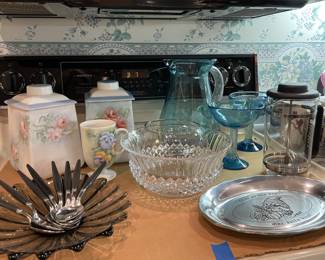 array of antique and vintage kitchenware, pitchers, french press, canisters