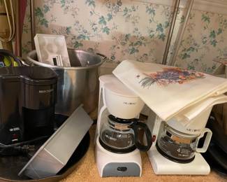 coffee makers in various sizes, kitchen linens