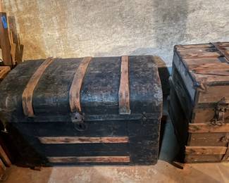 Antique trunks in various shapes, colors, and sizes