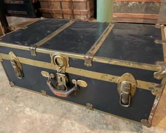 Antique trunks in various shapes, colors, and sizes