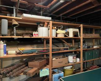 shop light, paint supplies, table legs, buckets, metal storage containers, step stool