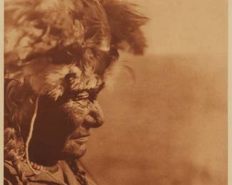 2016
Edward S. Curtis
1868-1952
"A Medicine Head-Dress - Blackfoot," Plate 638 From "The North American Indian" Volume 18
Photogravure in brown on tissue-thin Japanese paper
From the Suffolk Engraving Co., Cambridge, MA edition printed after the 1926 original photograph copyrighted by Curtis; with the title, plate number, copyright, publisher, and artist name all printed in the blank outside the image
Image: 15.125" H x 11.5" W; Sheet: 16.875" H x 12.625" W
Estimate: $200 - $400