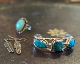Sterling silver jewelry pieces. 
Bracelet is a signed "Nez". Estate sale price: $250 
Feather earrings estate sale price: $40
Turquoise ring: $85