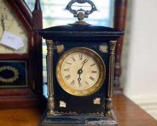 Antique cast iron clock with mother of pearl inlays on the corners and ornate handle. Estate sale price: $95