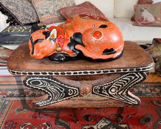 Antique ceramic cat on Oceanic headrest.