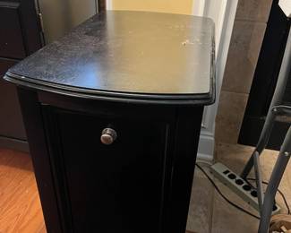 #53	black end table with hamper door flip down 16x26x25  (as is top)	 $40.00 			
