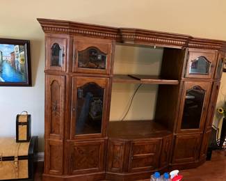 #68	5 pc. Entr. Center w/Sides that have 3 Top beveled Glass Doors & lighted Center, has 2 pull-out sides for DVDs on Bottom has 1 door & 2 slide-out Center - Must Take All and Move it Out - 105" Across x 23"D x 79"T  (each end 32"W)	 $125.00 			
