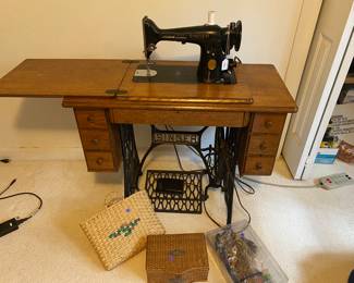RF24 - $150. Singer Sewing Machine with Treadle machine base. (This machine is electric)